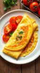 a golden classic french omelette garnished with herbs, served with tomatoes, on a rustic wooden table.