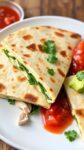 A plate of chicken and spinach quesadillas served with salsa and guacamole.