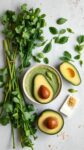 ingredients for a creamy green sauce including avocado, cilantro, and jalapeños